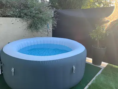 a large blue bath tub sitting in a yard at L'Escale in Meyreuil