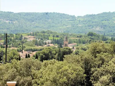 a town in the middle of a forest of trees at Pretty, spacious holiday home with private pool in Villes-sur-Auzon