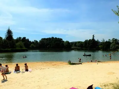 a group of people on the beach at a lake at Pretty, spacious holiday home with private pool in Villes-sur-Auzon