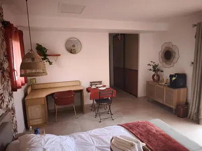 a bedroom with a bed and a desk and a table at Chambre chez l'habitant à Pernes les Fontaines in Pernes-les-Fontaines