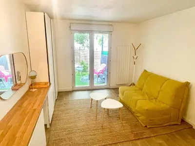a living room with a yellow couch and a table at Studio Coconing Aix-en-Provence in Aix-en-Provence