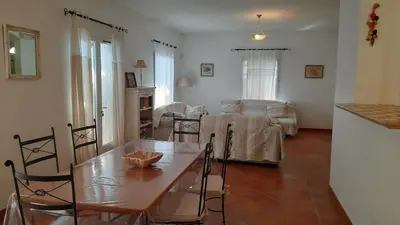a kitchen and living room with a table and chairs at Maison de vacances avec piscine privative, Oustau des Oliviers vue dominante Colorado provençal in Rustrel