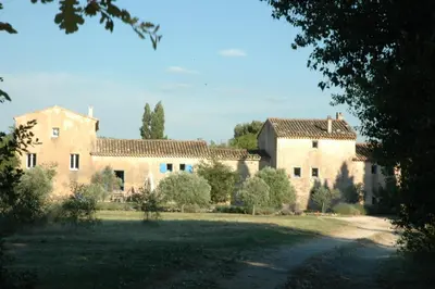 a large building with a yard in front of it at Le Mas Saint Jacques in Crillon-le-Brave
