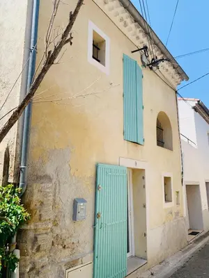 an old building with blue shutters on it at Le Nid Provençal in Lambesc
