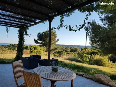 a table and chairs on a patio with a view at Appartement dans mas avec piscine privée sans vis a vis in Miramas