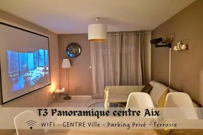 a living room with a tv and a couch at T3 Panoramique Centre Aix en Provence in Aix-en-Provence