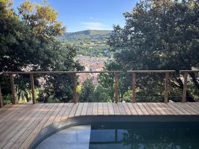 a wooden deck with a swimming pool with a view at Casa Lub in Apt