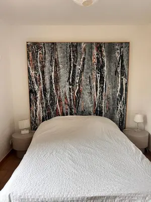a bedroom with a bed with a large headboard at Casa Lub in Apt