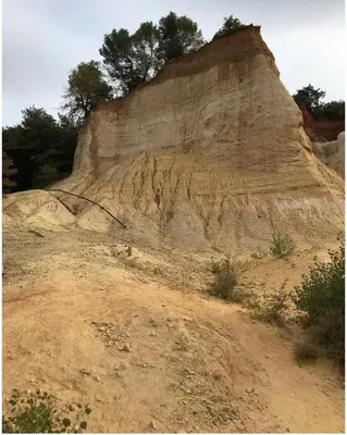 a rocky hill with trees on top of it at Casa Lub in Apt