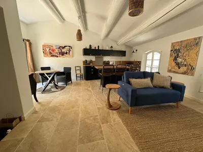 a living room with a blue couch and a table at La bohème in Lourmarin