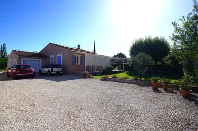 a house with a car parked in a driveway at Anna et Jean-Paul in LʼIsle-sur-la-Sorgue
