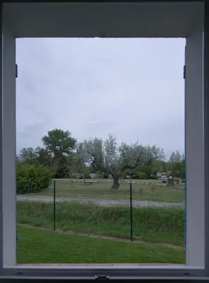 a window with a view of a field and a fence at Anna et Jean-Paul in LʼIsle-sur-la-Sorgue