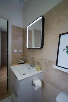 a bathroom with a sink and a mirror on the wall at Anna et Jean-Paul in LʼIsle-sur-la-Sorgue