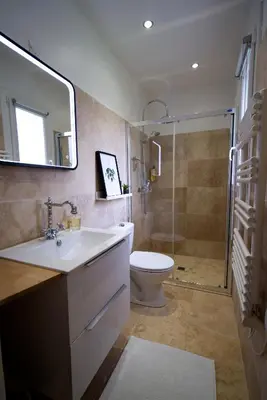a bathroom with a sink and a toilet and a mirror at Anna et Jean-Paul in LʼIsle-sur-la-Sorgue