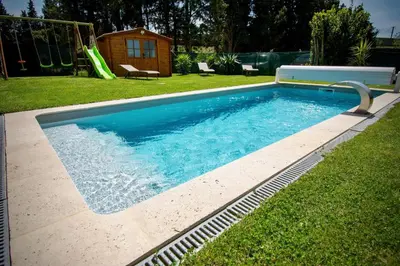 a swimming pool in a yard with a slide at Valentins cottage Moulin de Tartay Avignon in Avignon