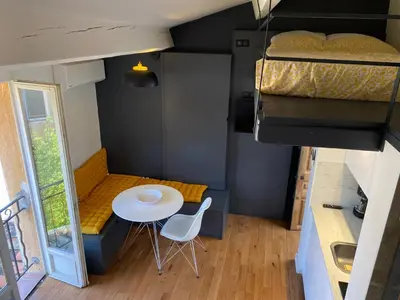 a small room with a table and a bed at Studio centre historique Aix en Provence in Aix-en-Provence