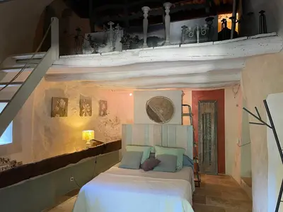 a bedroom with a bed in a room at Charmante Maison au cœur du village in Rustrel