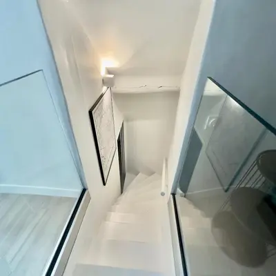 a staircase in a house with a glass wall at Centre Historique Appartement Climatisé avec terrasse in Aix-en-Provence