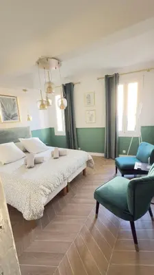 a bedroom with two beds and a couch and a chair at Appartement climatisé 2 chambres Centre historique in Aix-en-Provence
