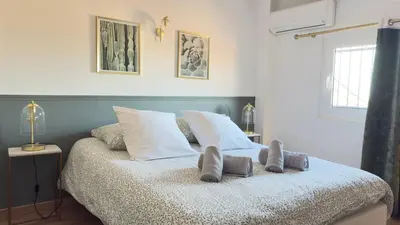 a bedroom with a bed with two towels on it at Appartement climatisé 2 chambres Centre historique in Aix-en-Provence