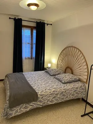 a bedroom with a large bed and a window at Domaine Camp Fourca in Mirabeau
