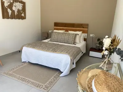 a bedroom with a large bed and a glass table at La bastide de marie in Robion en Luberon
