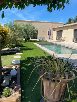 a yard with a swimming pool and a house at La bastide de marie in Robion en Luberon