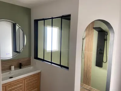 a bathroom with a sink and a mirror and a shower at Maison avec piscine et jacuzzi proche de la rivière idéale pour un séjour détente in Le Thor