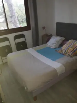 a bed in a room with a window at Studio 107 in Aix-en-Provence