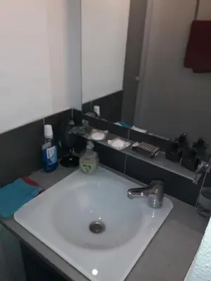 a white sink in a bathroom with a mirror at Studio 107 in Aix-en-Provence