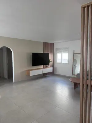 a living room with a flat screen tv on a wall at Villa Zen in Entraigues-sur-la-Sorgue