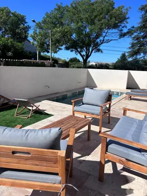 a group of chairs and tables next to a pool at Villa Zen in Entraigues-sur-la-Sorgue