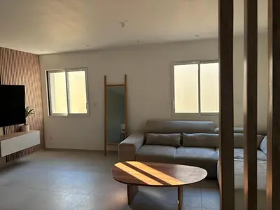 a living room with a couch and a table at Villa Zen in Entraigues-sur-la-Sorgue
