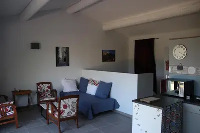 a living room with a blue couch and chairs at La cigale bleue in Gordes