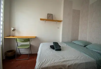 a bedroom with a bed and a desk and a chair at Cosy et lumineux - hyper centre - wifi in Aix-en-Provence
