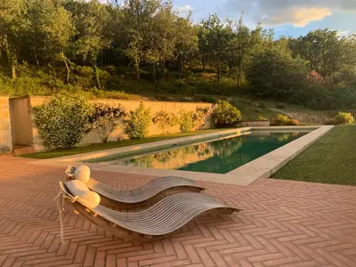 a bench sitting next to a swimming pool at Les Noyers in Montjustin