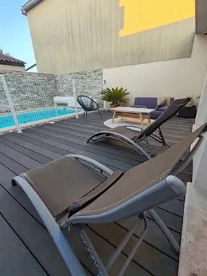 a deck with chairs and a table and a pool at Chambre d'hôtes privée et indépendante avec piscine in Salon-de-Provence