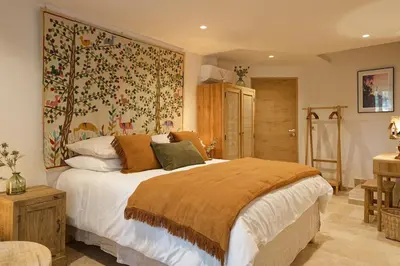 a bedroom with a large bed and a tapestry at Maison Paulette in Eygalières