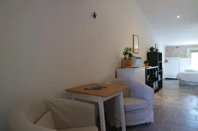 a living room with two chairs and a table at Le Mas de Loume in Sault-de-Vaucluse