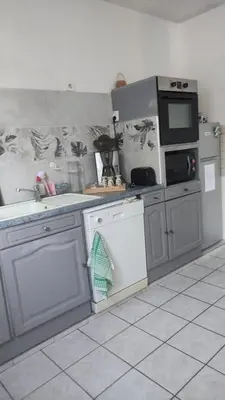 a kitchen with a sink and a stove top oven at L'Appart in Cheval-Blanc