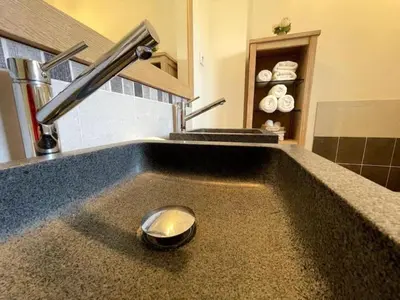 a kitchen counter with a sink with a faucet at Le petit paradis au cœur du Luberon in Saint-Saturnin-les-Apt