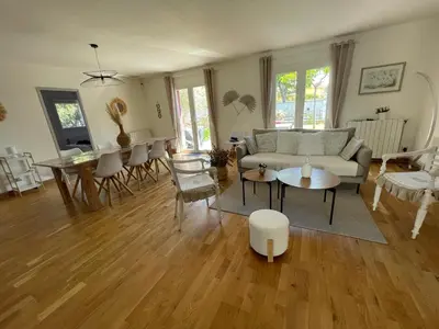 a living room with a couch and a table at A l'ombre des oliviers in LʼIsle-sur-la-Sorgue