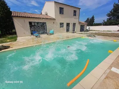 a swimming pool in front of a house at Villa moderne avec piscine in Monteux