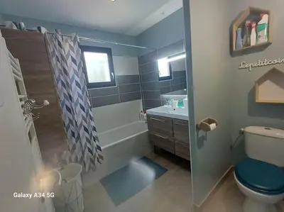 a bathroom with a tub and a toilet and a sink at Villa moderne avec piscine in Monteux