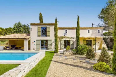 a house with a swimming pool and a yard at Villa Les Alpilles by Villa Plus in Mouriès
