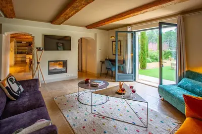 a living room with a couch and a table at Villa Les Alpilles by Villa Plus in Mouriès