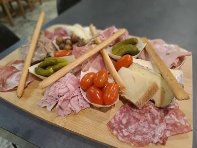 a plate of food with meat and vegetables on a table at Escapade sous les pins 20m2 in Aurons