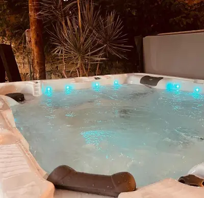 a jacuzzi tub with blue lights in it at Évasion charme et jacuzzi en pleine nature in Grans