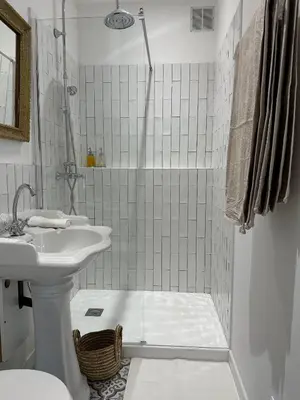 a white bathroom with a sink and a shower at Studio centre ville la Toscane in LʼIsle-sur-la-Sorgue