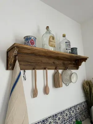 a shelf with bottles and spoons on a wall at Studio centre ville la Toscane in LʼIsle-sur-la-Sorgue